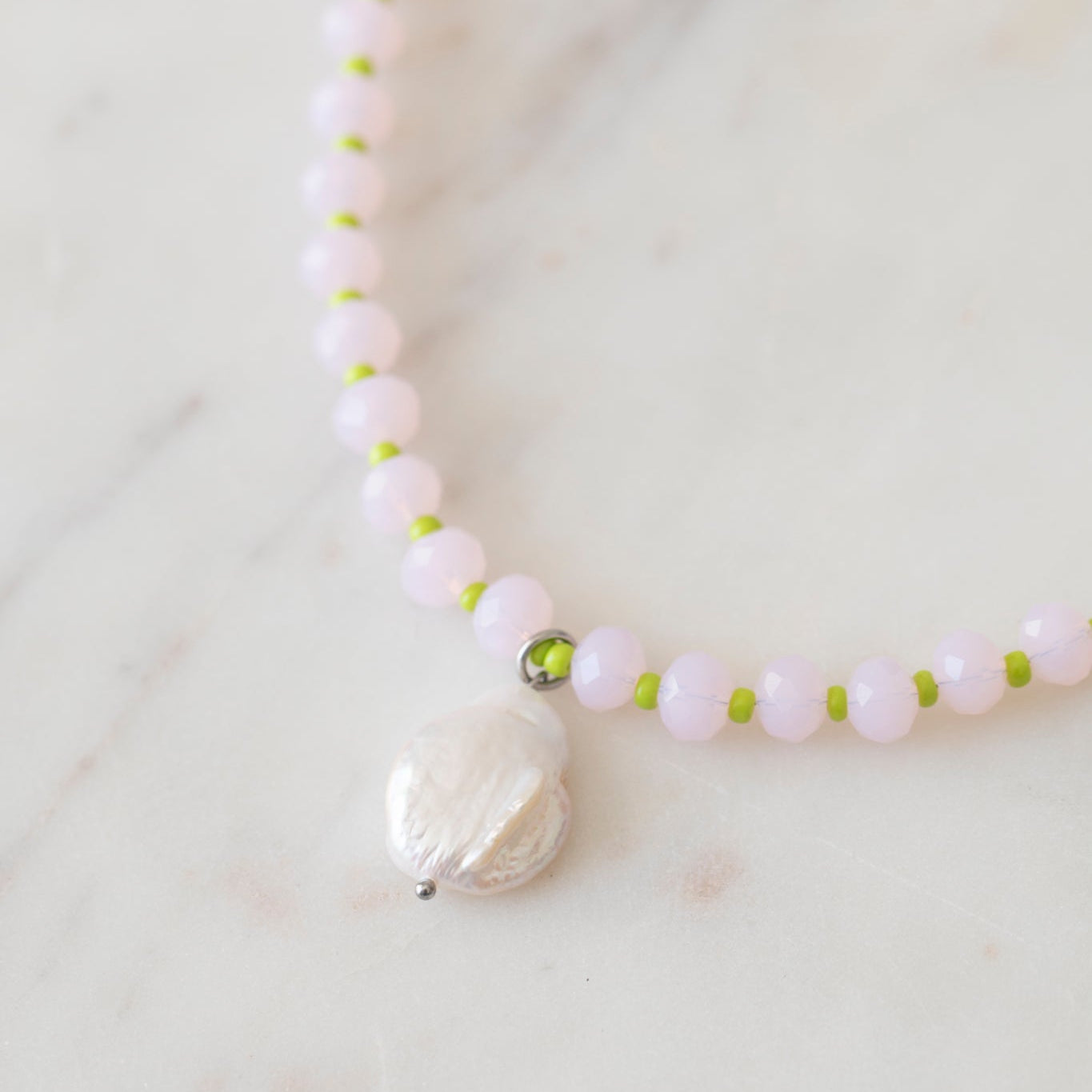 Necklace with pink and lime beads with a freshwater pearl pendant.